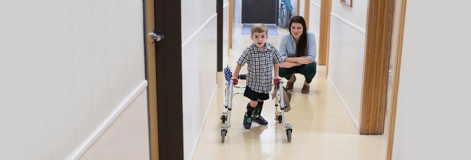 boy with orthotics using walker-with Cassandra observing